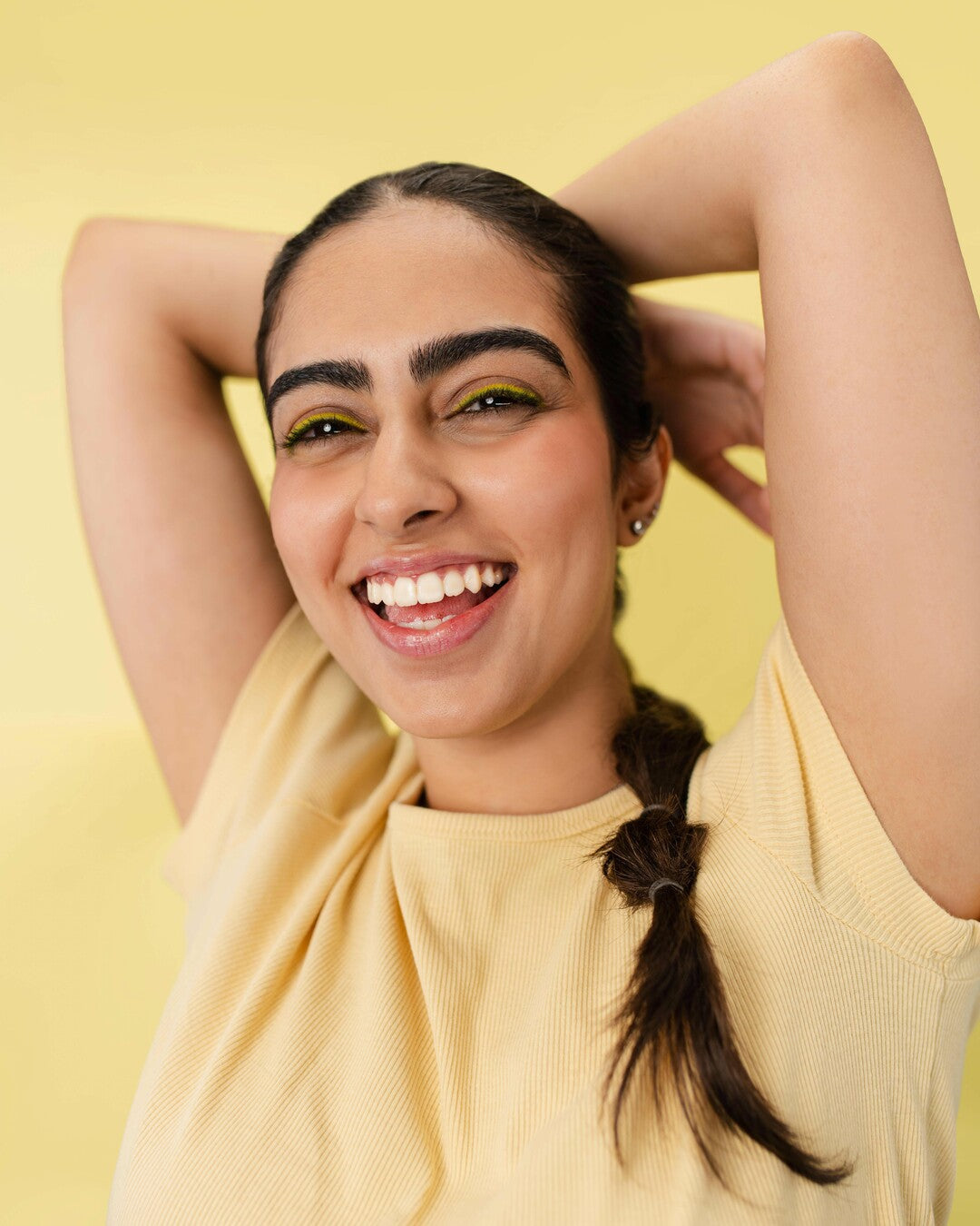 girl wearing a yellow shirt smiling